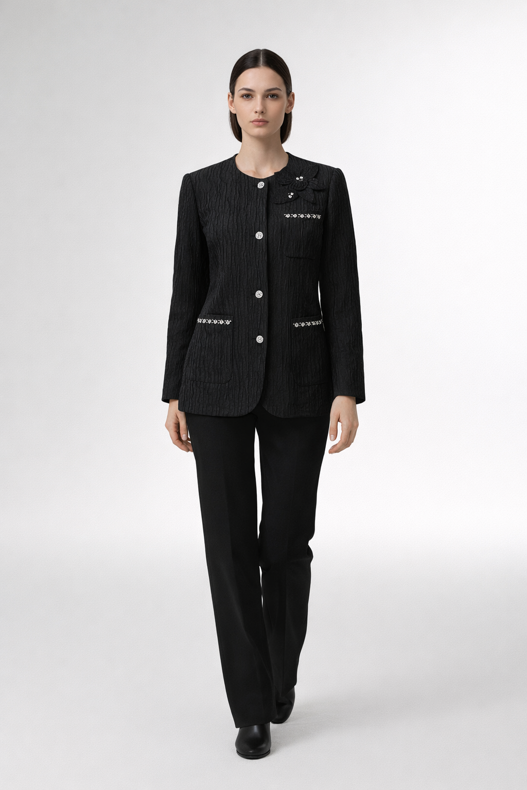 Black textured jacket with round neckline and decorative buttons