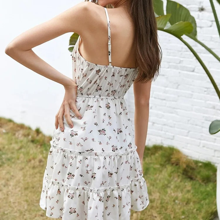 White floral mini dress with spaghetti straps and ruffle hem